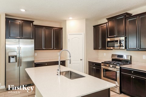 a kitchen with stainless steel appliances and a white counter top