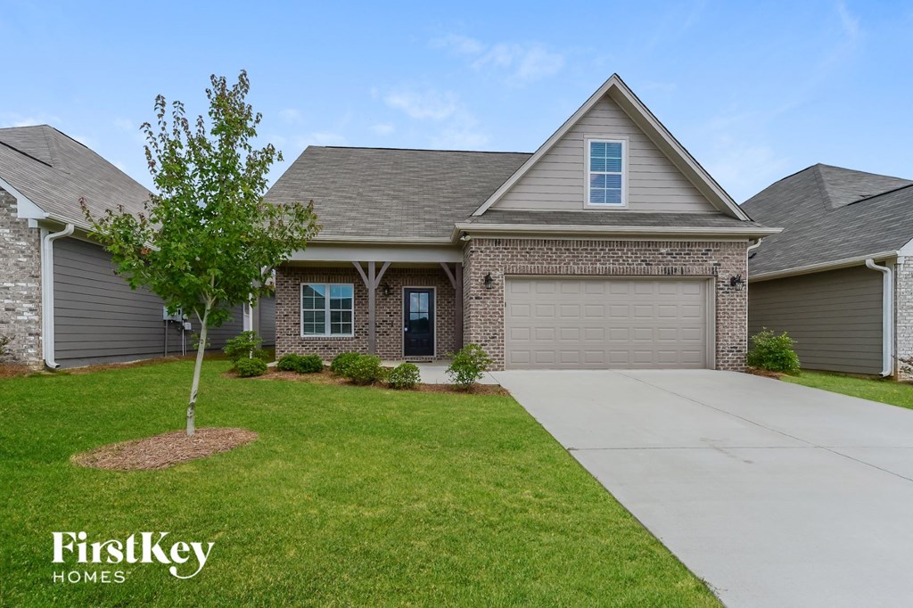 a home with a garage door and a lawn