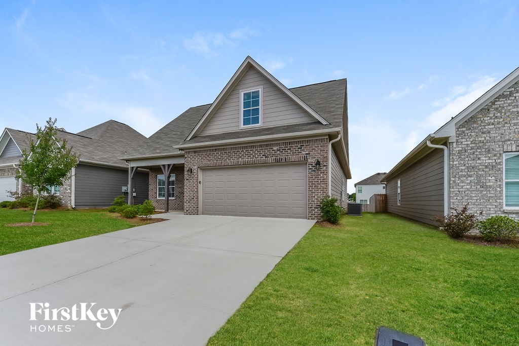 a large house with a driveway and a garage door