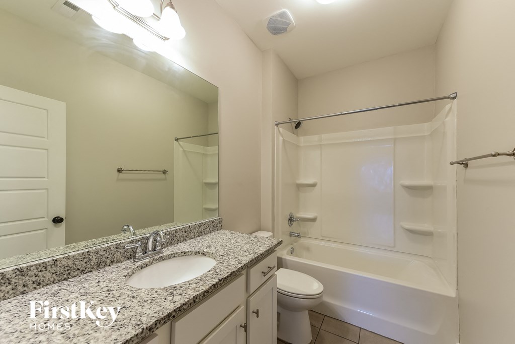 a bathroom with a sink and a shower and a toilet