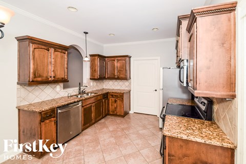 a kitchen with wooden cabinets and stainless steel appliances