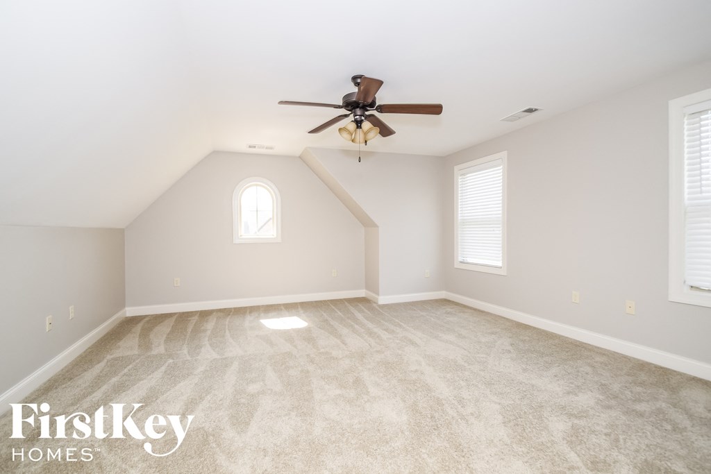the master bedroom is spacious and has a ceiling fan