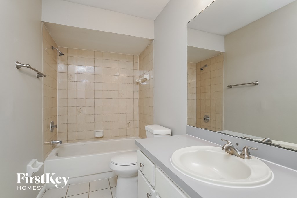 a bathroom with a sink and a toilet and a bath tub