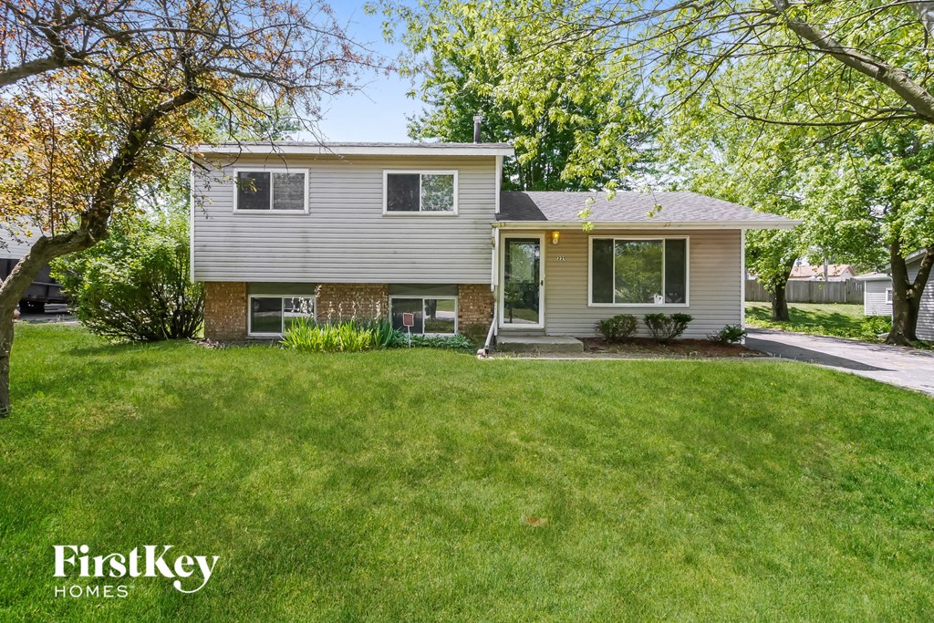 A house with a lawn in front of it.