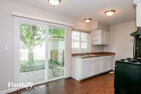 A kitchen with a stove top oven and a sink.