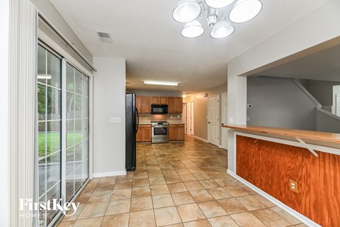 A kitchen with a tile floor and a wooden counter.