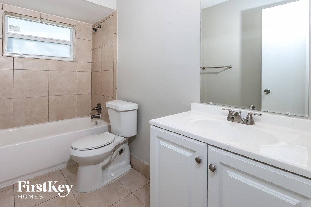 a bathroom with a sink toilet and a bath tub