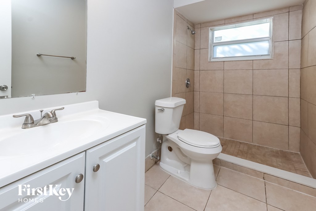a bathroom with a toilet and a sink and a mirror