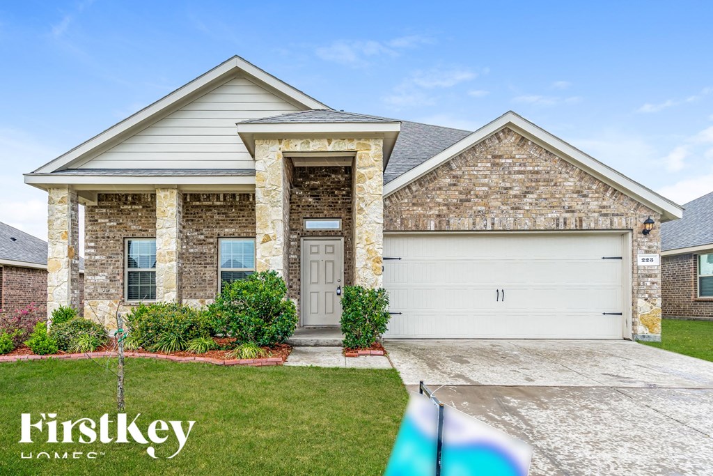 a house with a flag on the sidewalk in front of it