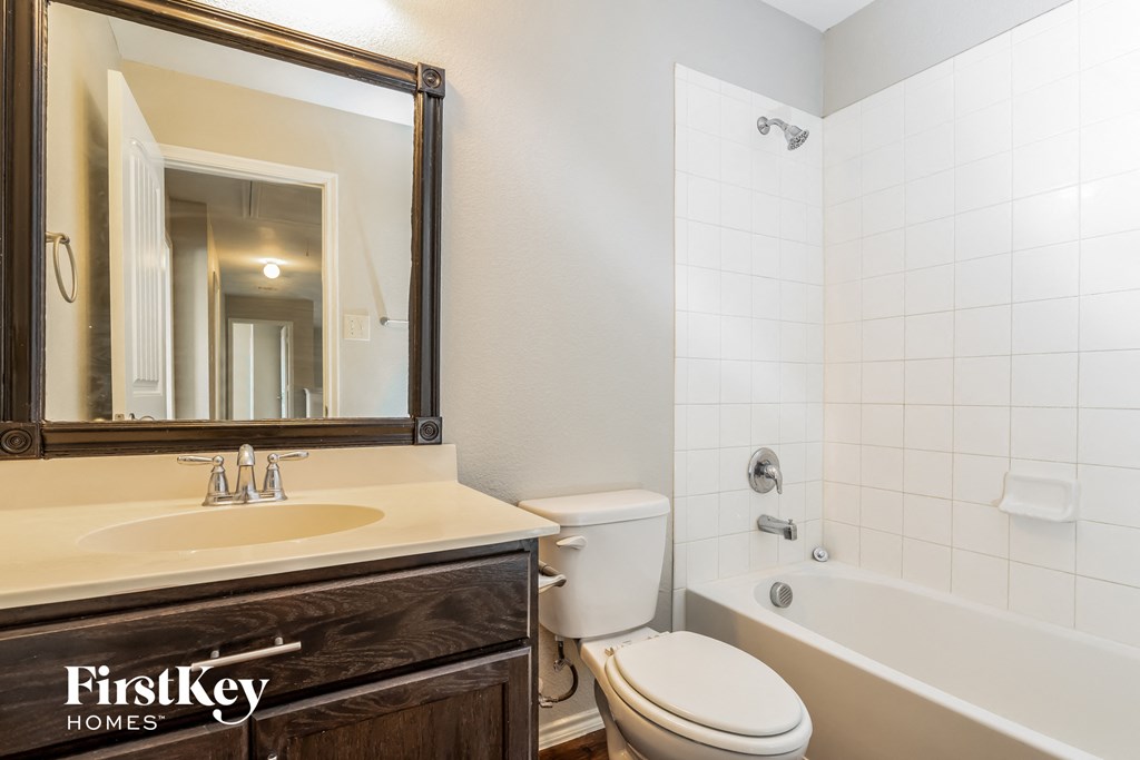 the bathroom is clean and ready to use with the tub and toilet