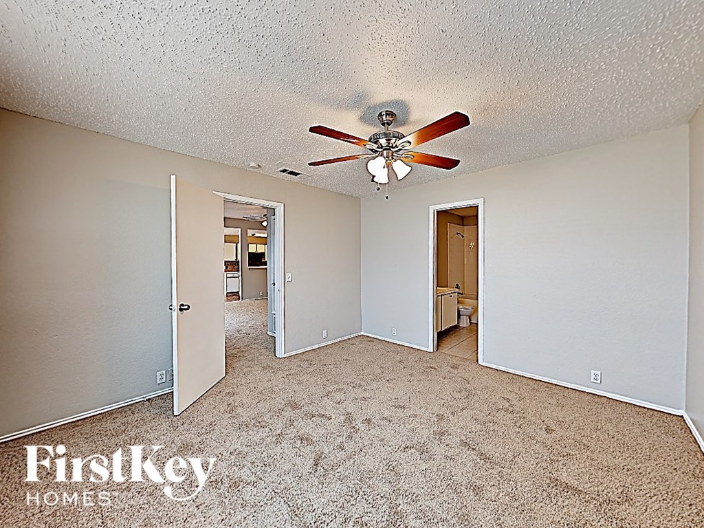 a bedroom with a ceiling fan and a carpeted floor
