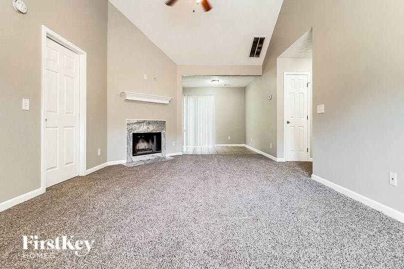 an empty living room with a fireplace