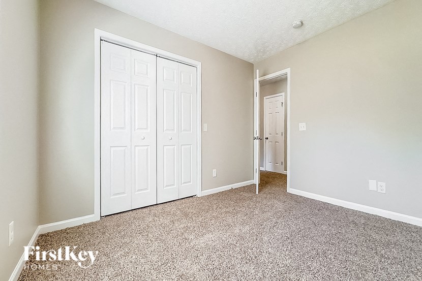 a bedroom with two closets and a white door