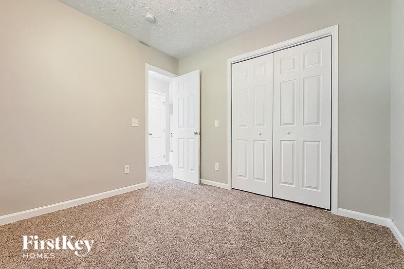 a bedroom with two closets and two doors