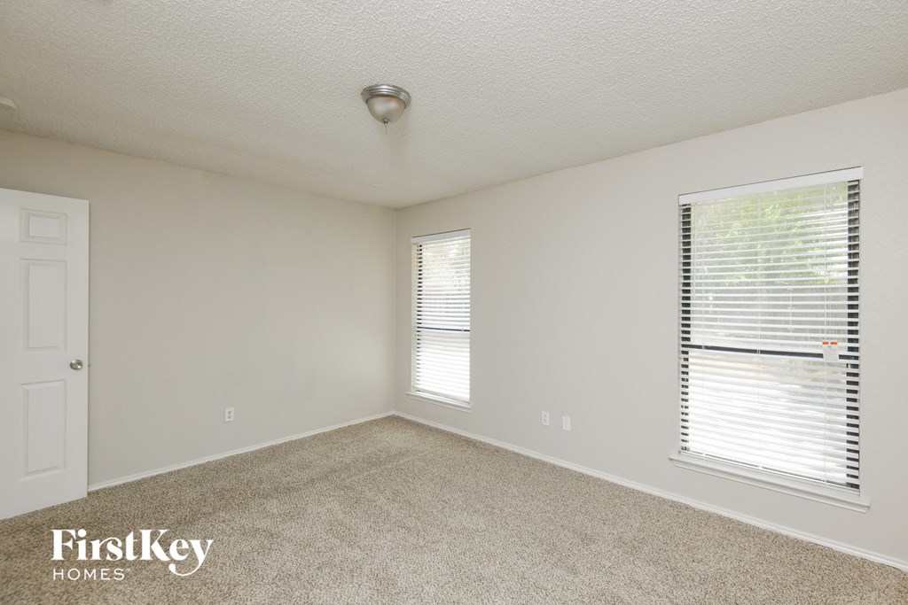 an empty room with a window and a door