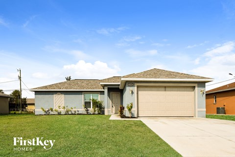 a house with a garage door and a lawn