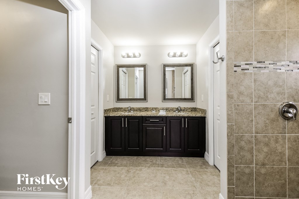 a bathroom with a sink and a mirror and a shower