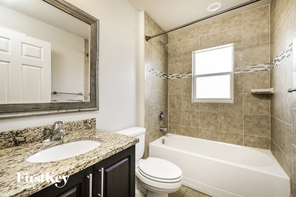 a bathroom with a sink toilet and a bath tub