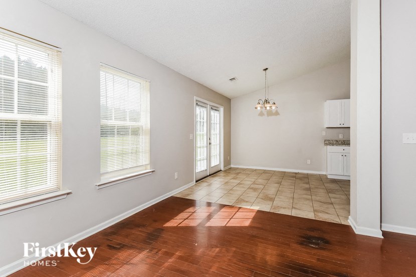 A room with wooden floors and a chandelier.