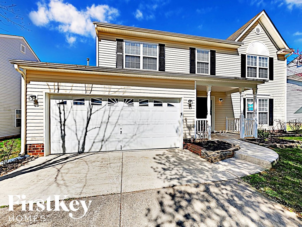 A two-story house with a garage is for sale.