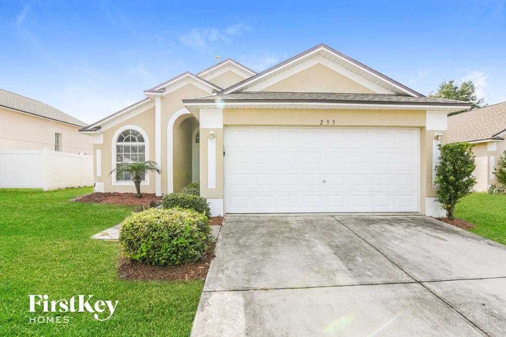 A two-story house with a garage is for sale.