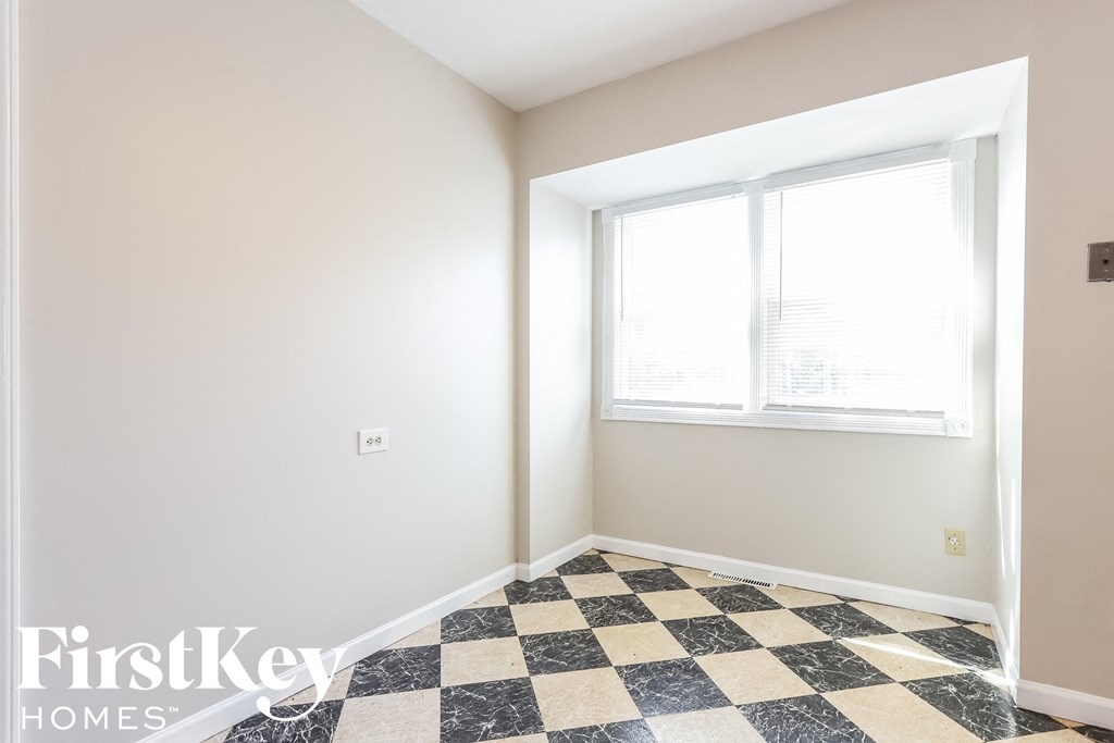 A room with a checkered floor and a window.