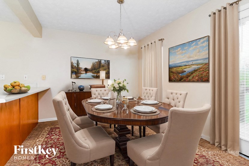 A dining room with a wooden table and chairs.