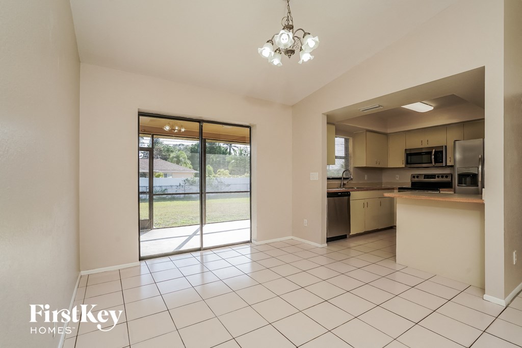 an empty kitchen with a sliding glass door to the patio