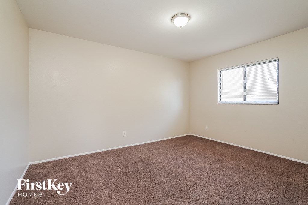 a room with a carpeted floor and a window