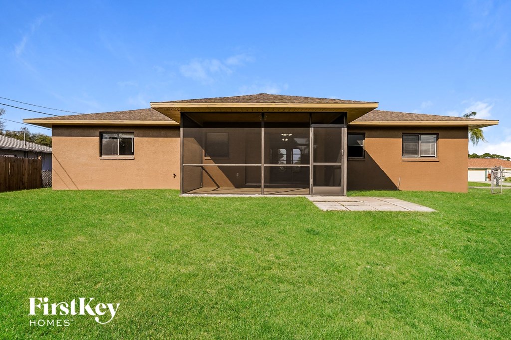 a home with a patio and a lawn