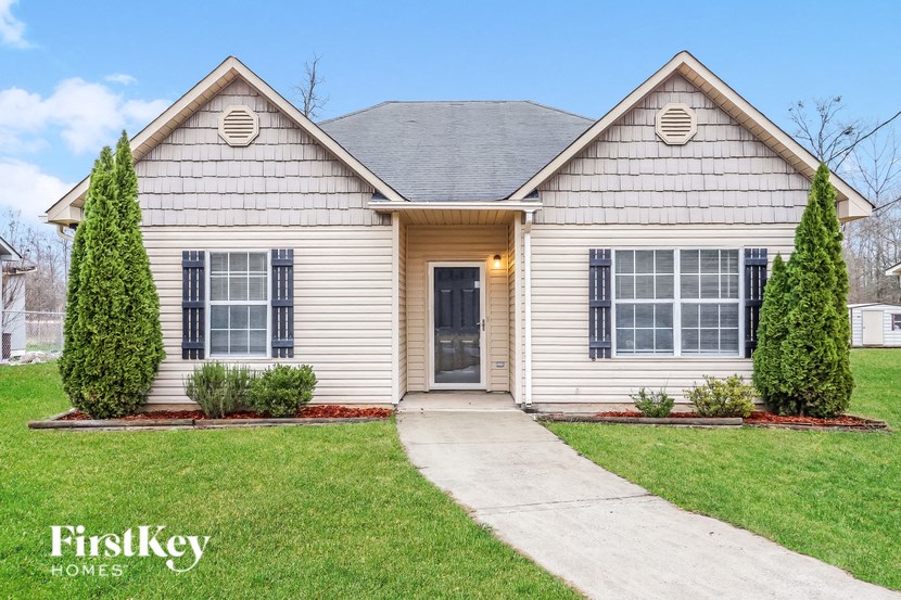 A house with a grey roof and a brown door is shown.