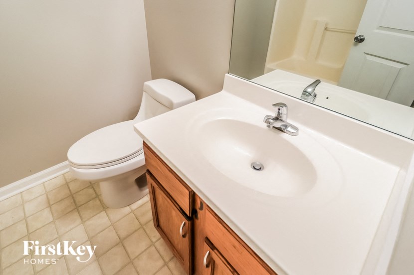 A white toilet sits next to a sink in a bathroom.