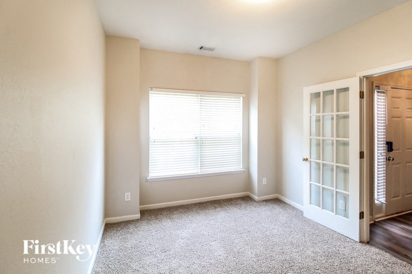 an empty room with a door and a window