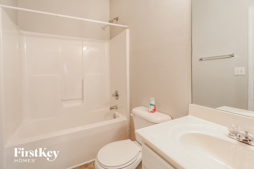 a bathroom with a sink toilet and a bath tub