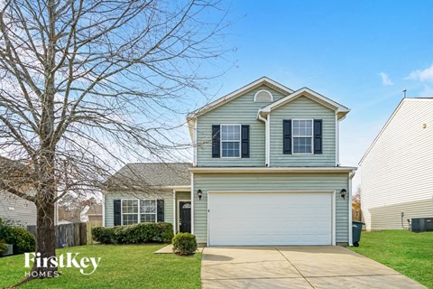 A two-story house with a garage is for sale.