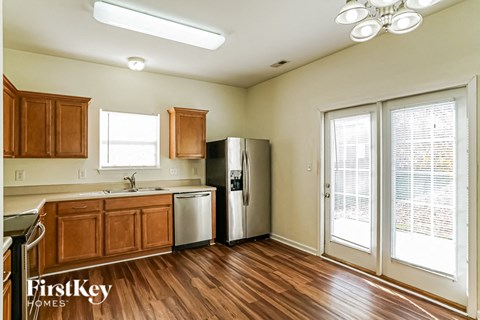 A kitchen with wooden cabinets and a refrigerator.