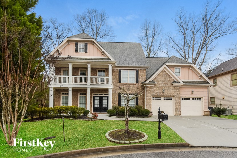 A large brick house with a black mailbox in front.