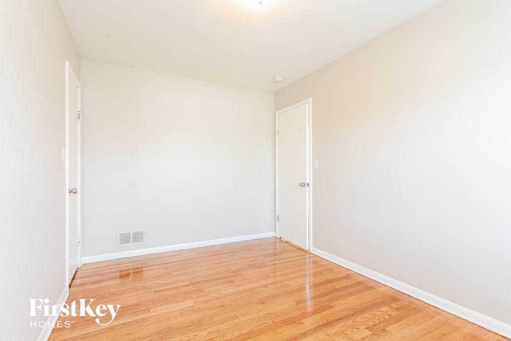 A room with wooden floors and white walls.