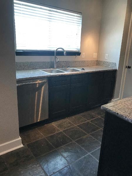 a kitchen with a sink and a window