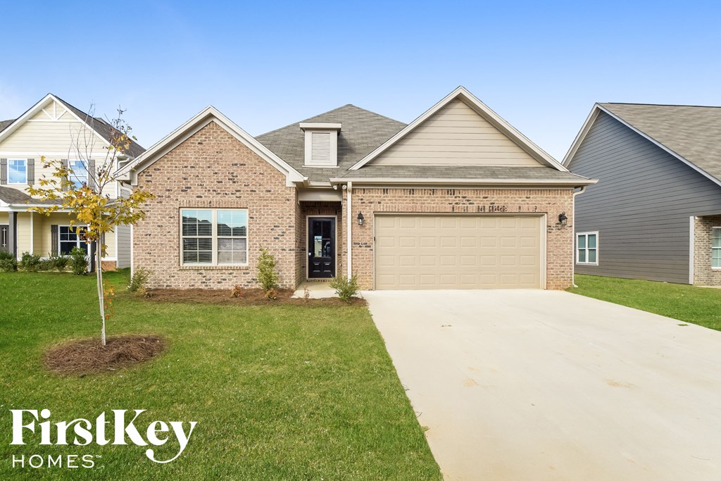 a brick house with a garage and a driveway