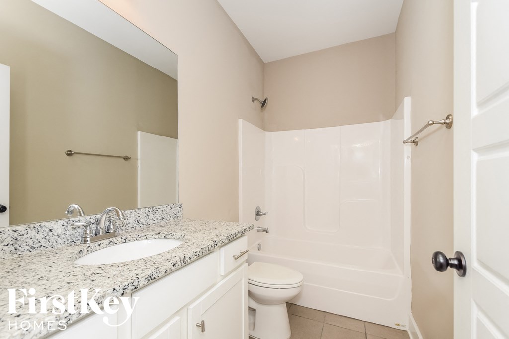 a bathroom with a sink and a toilet and a tub