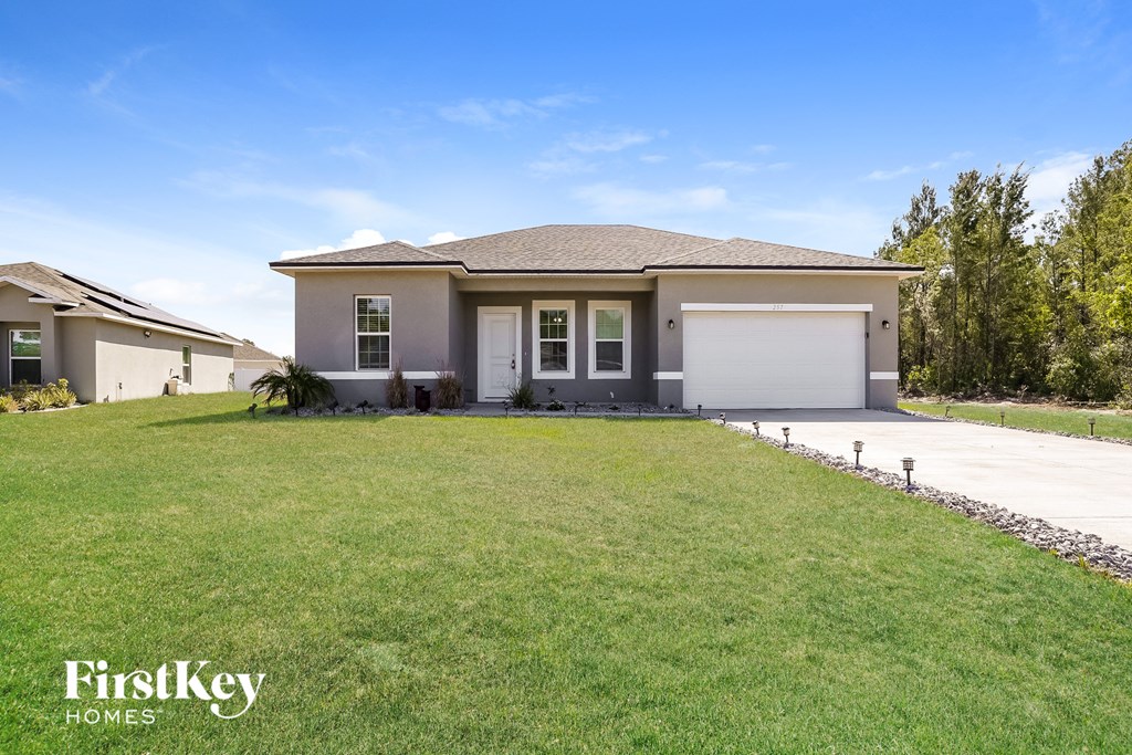 a house with a lawn and a garage door