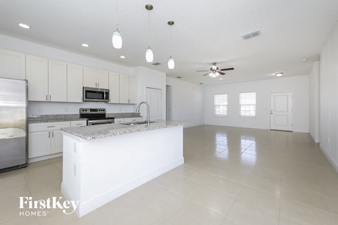 a large kitchen with white cabinets and a white counter top