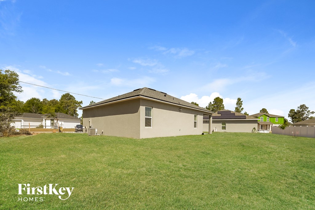 a house on a hill with a grassy yard
