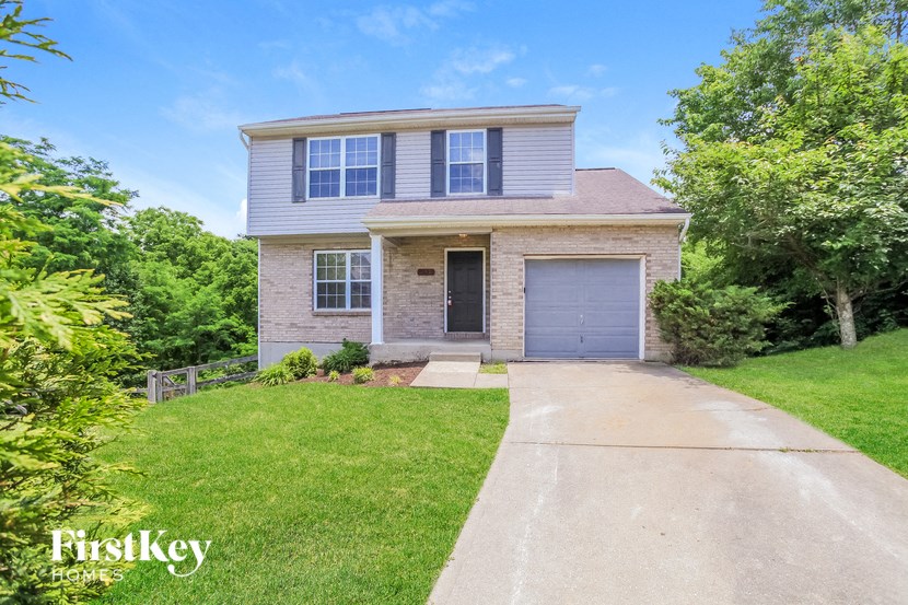 a brick house with a blue garage door and a driveway