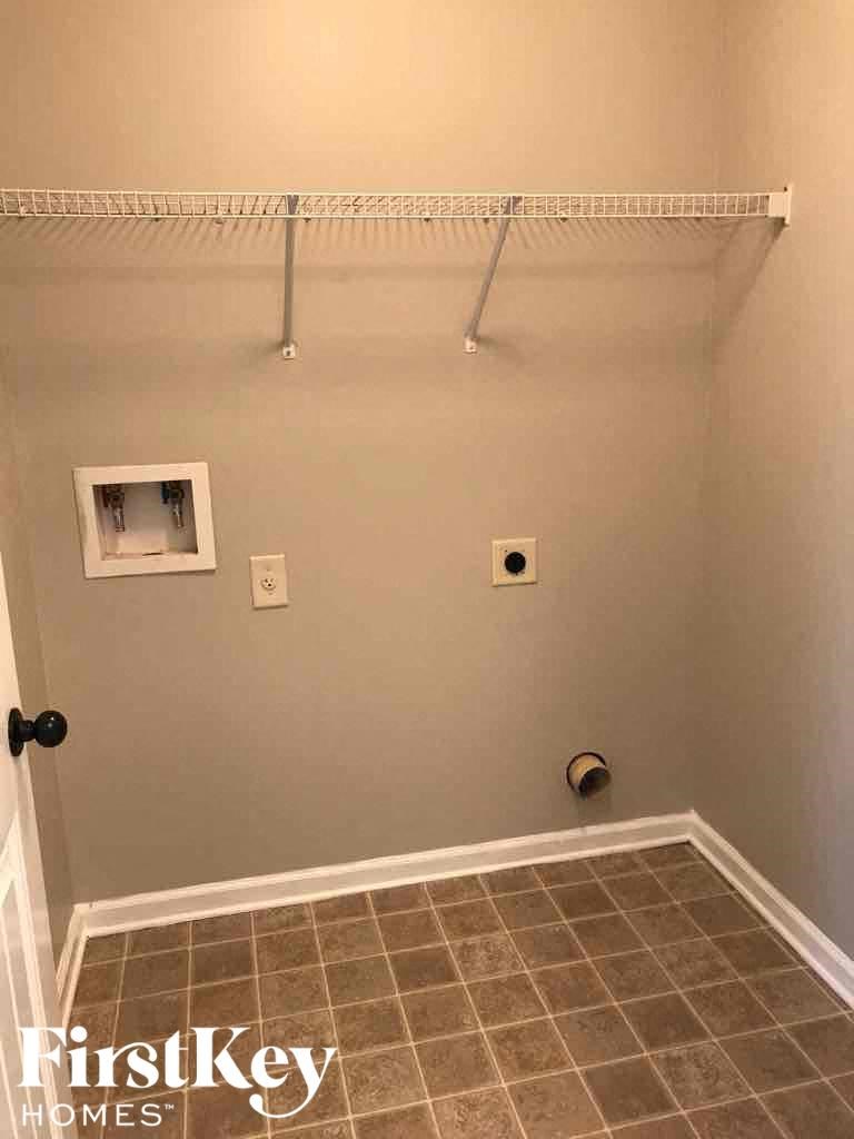 A small room with a tile floor and a white wall.