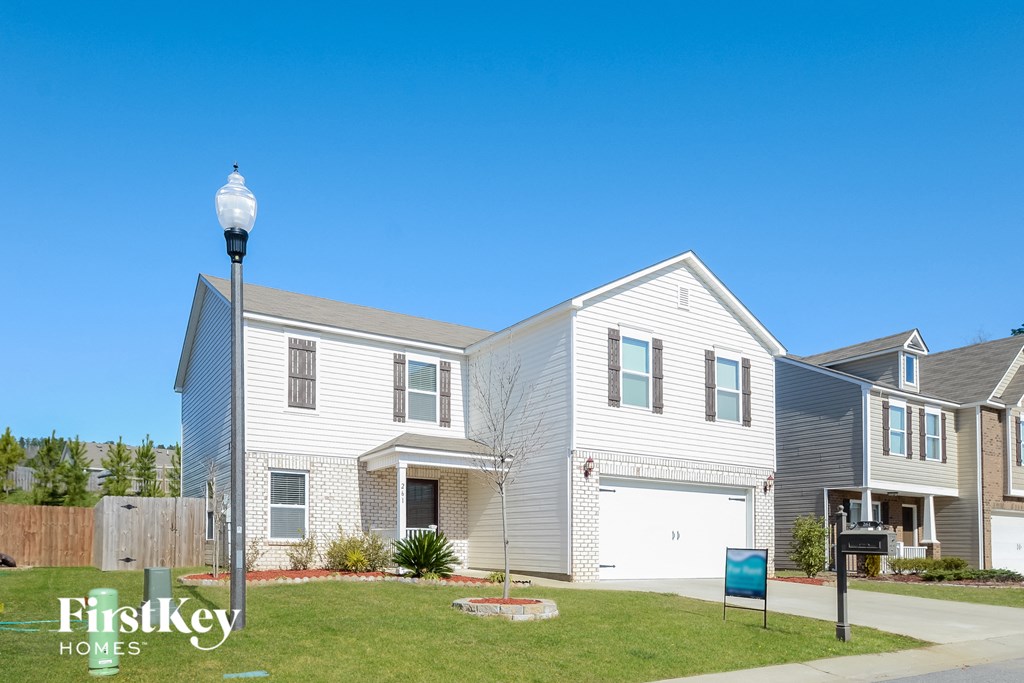 two story home with white siding and a white garage door