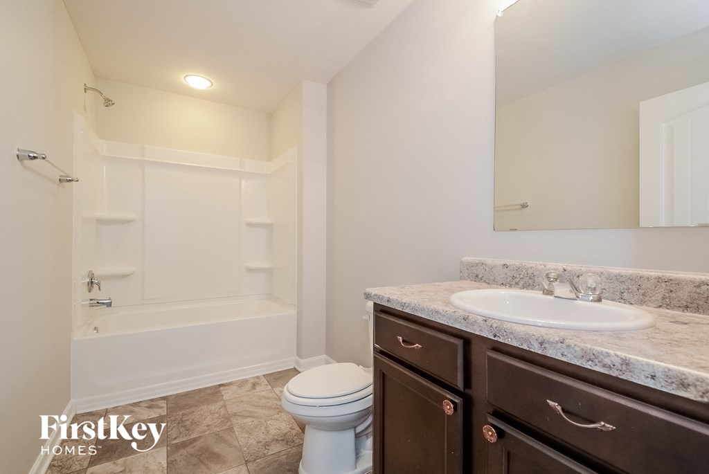 a bathroom with a sink toilet and a bath tub