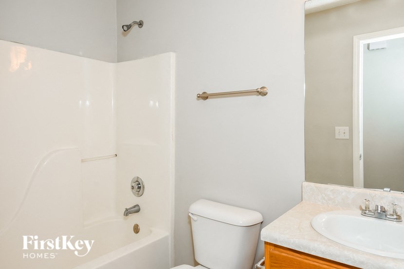 a small bathroom with a toilet and a tub and a sink