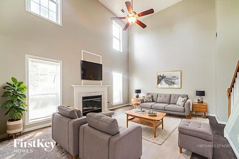 A living room with a grey couch and a wooden coffee table.